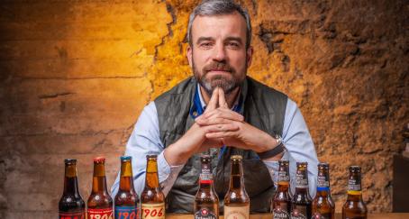 Santiago Miguelez posando con botellas de cerveza de Hijos de rivera